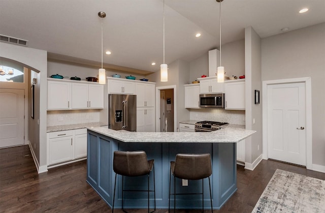 9180 Geanna Ct, West Des Moines, IA 50266 - kitchen with premium appliances, decorative backsplash, white cabinets, a center island, and dark wood-style floors