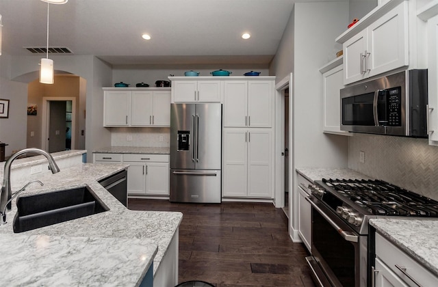 9180 Geanna Ct, West Des Moines, IA 50266 - kitchen featuring stainless steel appliances, decorative backsplash, white cabinetry, dark wood-style floors, and recessed lighting