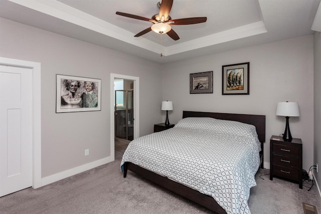 9180 Geanna Ct, West Des Moines, IA 50266 - bedroom with carpet, a raised ceiling, a ceiling fan, and ensuite bathroom