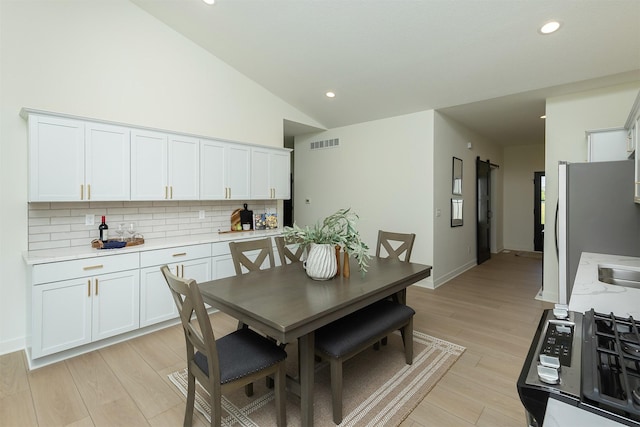 2004 Ammann Dr, Adel, IA 50003 - dining room with lofted ceiling, light wood finished floors, and recessed lighting