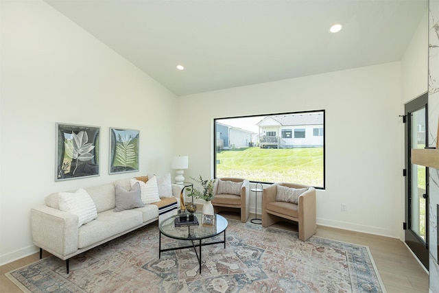 2004 Ammann Dr, Adel, IA 50003 - living area featuring light wood finished floors, recessed lighting, and lofted ceiling