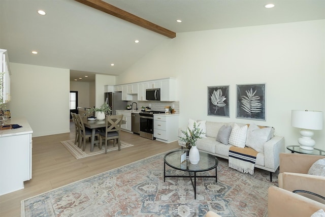 2004 Ammann Dr, Adel, IA 50003 - living area featuring light wood-style floors, beam ceiling, recessed lighting, and high vaulted ceiling