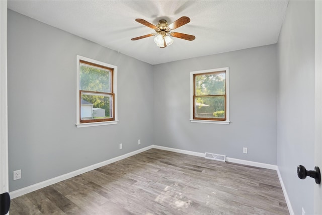 2515 Glenbrook Dr, Des Moines, IA 50316 - unfurnished room with plenty of natural light, ceiling fan, and wood finished floors
