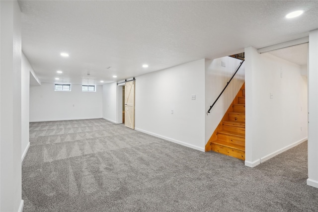 2515 Glenbrook Dr, Des Moines, IA 50316 - basement featuring recessed lighting, carpet, a barn door, stairway, and a textured ceiling