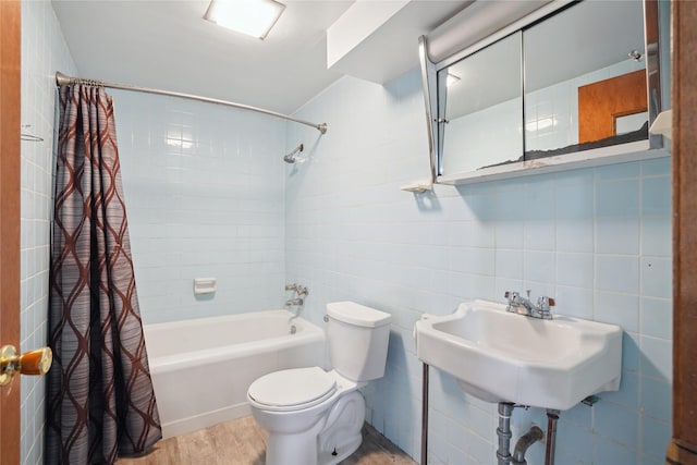 2515 Glenbrook Dr, Des Moines, IA 50316 - full bath featuring shower / bath combo with shower curtain, wood finished floors, and tile walls