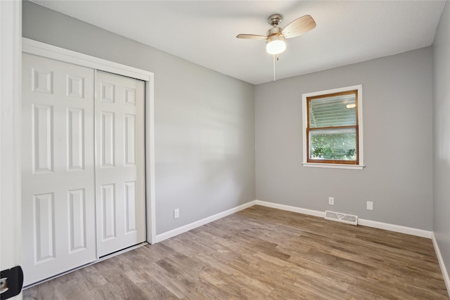 2515 Glenbrook Dr, Des Moines, IA 50316 - unfurnished bedroom with wood finished floors, a closet, and a ceiling fan