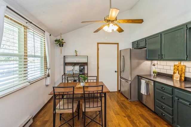 926 Casady Dr, Norwalk, IA 50211 - kitchen with green cabinets, vaulted ceiling, appliances with stainless steel finishes, ceiling fan, and tasteful backsplash