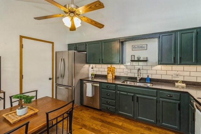 926 Casady Dr, Norwalk, IA 50211 - kitchen with appliances with stainless steel finishes, green cabinets, dark countertops, ceiling fan, and backsplash