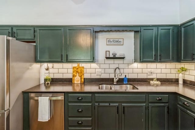 926 Casady Dr, Norwalk, IA 50211 - kitchen featuring stainless steel appliances, green cabinetry, dark countertops, and tasteful backsplash