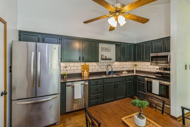 926 Casady Dr, Norwalk, IA 50211 - kitchen with appliances with stainless steel finishes, dark countertops, tasteful backsplash, and dark wood-type flooring