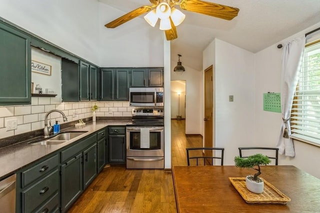 926 Casady Dr, Norwalk, IA 50211 - kitchen with appliances with stainless steel finishes, dark wood-style flooring, green cabinetry, and dark countertops
