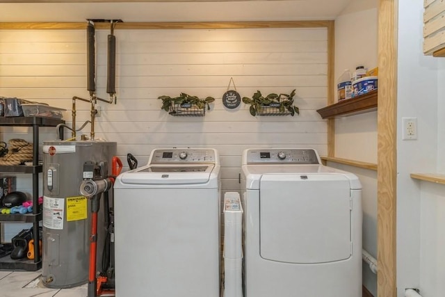 926 Casady Dr, Norwalk, IA 50211 - laundry area featuring electric water heater, washing machine and dryer, and wooden walls