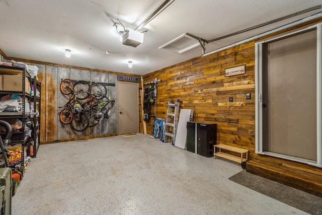 926 Casady Dr, Norwalk, IA 50211 - garage featuring a garage door opener and wood walls
