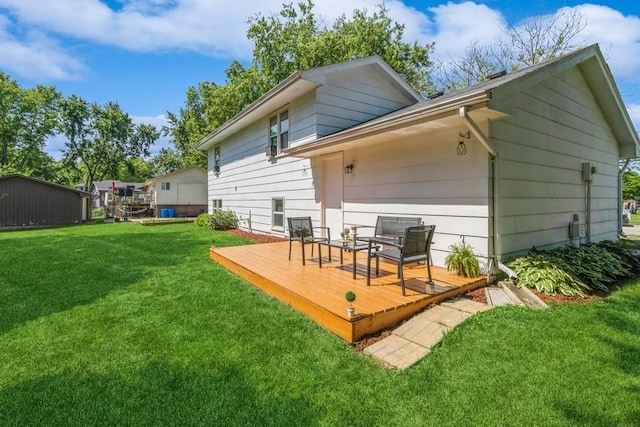 926 Casady Dr, Norwalk, IA 50211 - back of property featuring a deck and a lawn