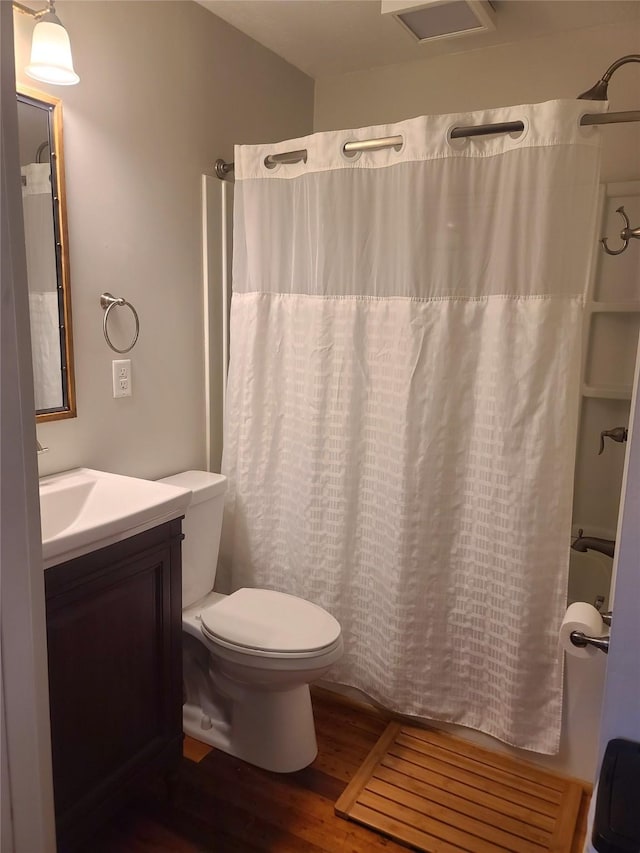 707 E 27th St S, Newton, IA 50208 - bathroom with wood finished floors, vanity, and shower / bath combination with curtain
