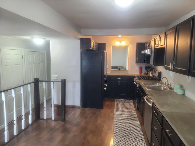 707 E 27th St S, Newton, IA 50208 - kitchen featuring appliances with stainless steel finishes, under cabinet range hood, and dark wood-style flooring