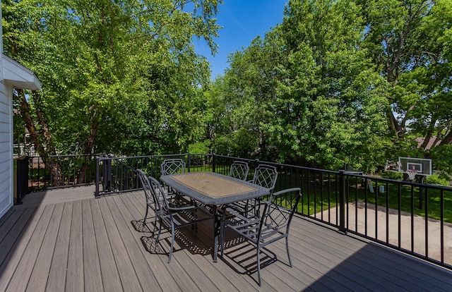 6511 NW 93rd St, Johnston, IA 50131 - deck featuring outdoor dining space and view of wooded area