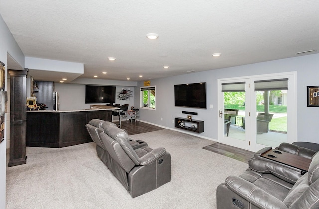 6511 NW 93rd St, Johnston, IA 50131 - living room with light colored carpet, recessed lighting, and a textured ceiling