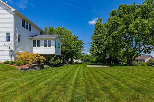 6511 NW 93rd St, Johnston, IA 50131 - view of grassy yard with stairway and a sunroom