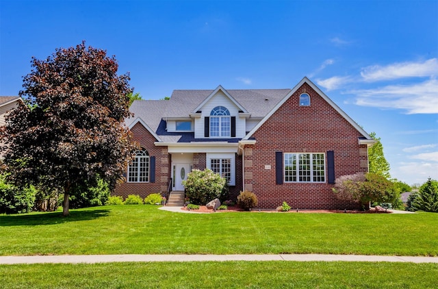 6511 NW 93rd St, Johnston, IA 50131 - traditional-style house with brick siding and a front lawn