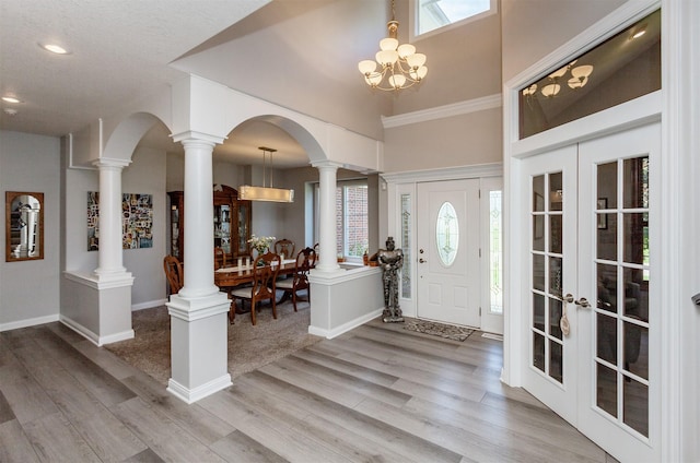 6511 NW 93rd St, Johnston, IA 50131 - foyer entrance with wood finished floors, a chandelier, french doors, recessed lighting, and a towering ceiling