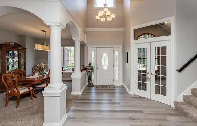 6511 NW 93rd St, Johnston, IA 50131 - entrance foyer featuring a towering ceiling, french doors, arched walkways, decorative columns, and stairway