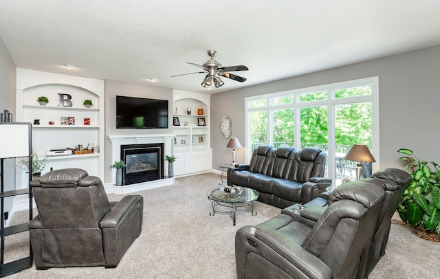 6511 NW 93rd St, Johnston, IA 50131 - carpeted living area with ceiling fan, a high end fireplace, and built in features