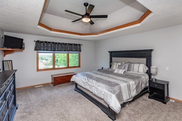 6511 NW 93rd St, Johnston, IA 50131 - bedroom with a tray ceiling, carpet floors, ceiling fan, and a textured ceiling