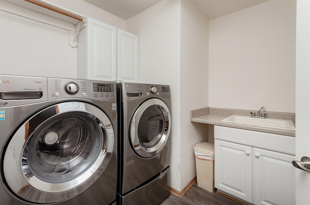 6511 NW 93rd St, Johnston, IA 50131 - washroom featuring washing machine and clothes dryer, cabinet space, and wood finished floors