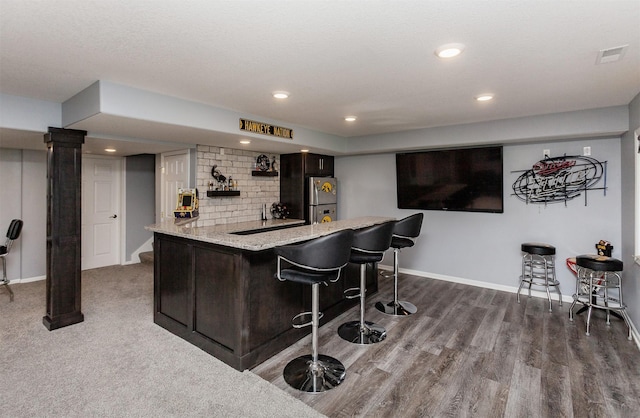 6511 NW 93rd St, Johnston, IA 50131 - indoor wet bar featuring freestanding refrigerator, wood finished floors, recessed lighting, and backsplash