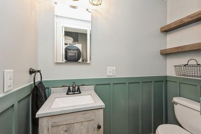 1418 Rapids St, Adel, IA 50003 - half bath featuring vanity, a decorative wall, and wainscoting