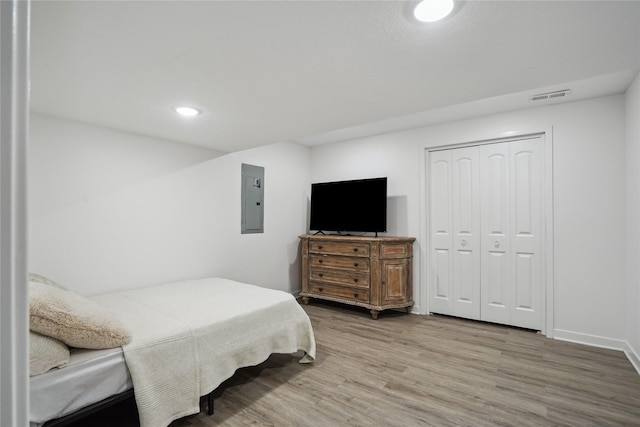 2814 Long Ave, Van Meter, IA 50261 - bedroom featuring electric panel, wood finished floors, recessed lighting, and a closet