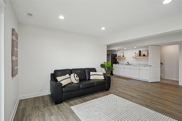 2814 Long Ave, Van Meter, IA 50261 - living area with wet bar, light wood-style floors, and recessed lighting