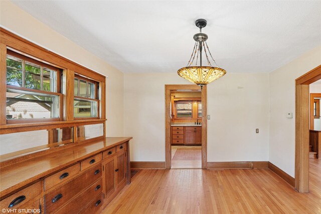 3320 SW 12th St, Des Moines, IA 50315 - dining area featuring baseboards and light wood-style flooring