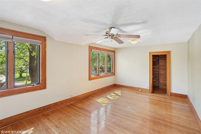 3320 SW 12th St, Des Moines, IA 50315 - spare room featuring light wood-style flooring, healthy amount of natural light, a textured ceiling, and a ceiling fan