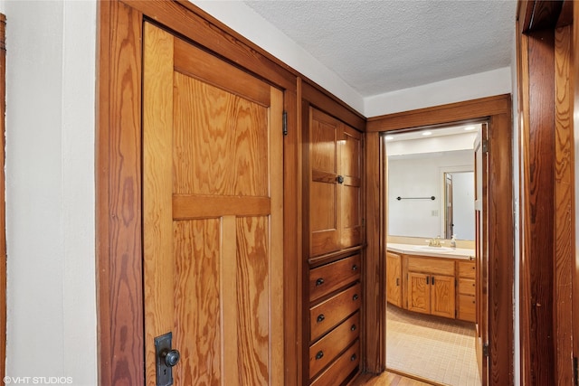 3320 SW 12th St, Des Moines, IA 50315 - bathroom with vanity, a textured ceiling, and wood finished floors