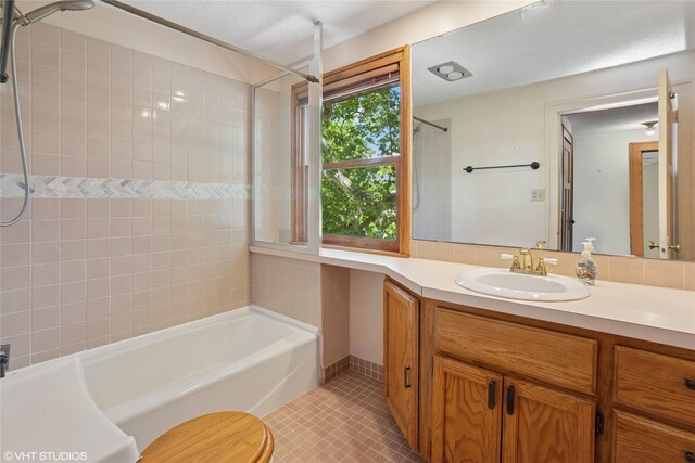 3320 SW 12th St, Des Moines, IA 50315 - full bath with a tub to relax in, vanity, tile patterned flooring, and a shower
