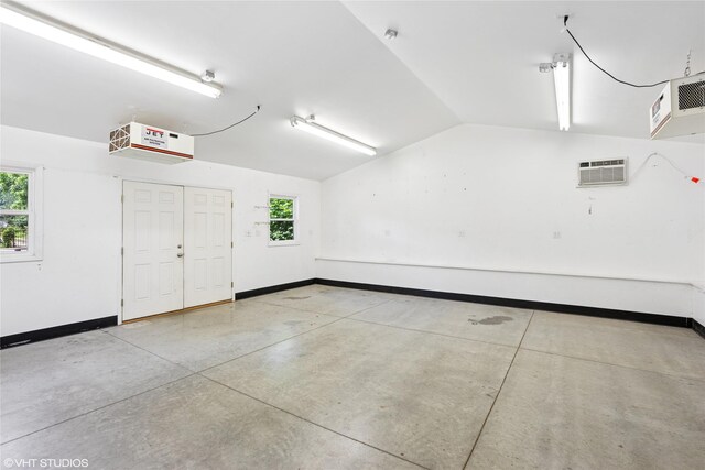 3320 SW 12th St, Des Moines, IA 50315 - garage with baseboards and a wall mounted air conditioner