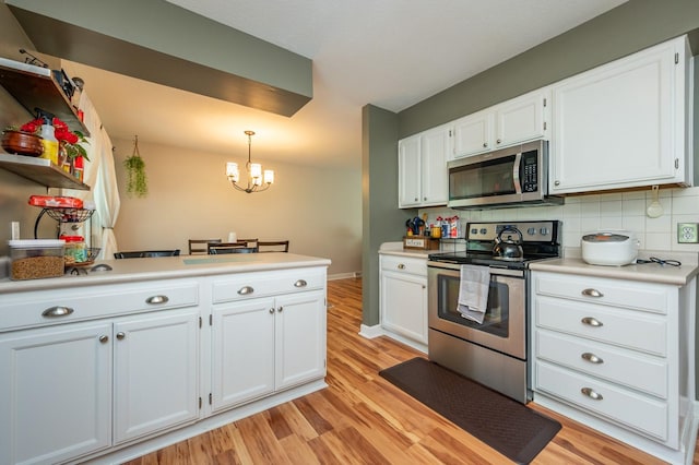 4012 79th St, Urbandale, IA 50322 - kitchen featuring appliances with stainless steel finishes, light wood-type flooring, white cabinets, and backsplash