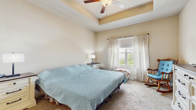 469 SE Hollow Ct, West Des Moines, IA 50265 - bedroom with light colored carpet, ceiling fan, and a tray ceiling