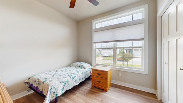469 SE Hollow Ct, West Des Moines, IA 50265 - bedroom with wood finished floors and ceiling fan