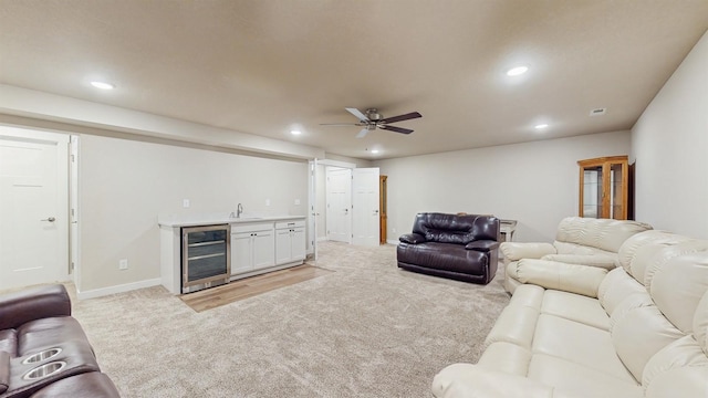 469 SE Hollow Ct, West Des Moines, IA 50265 - living area featuring beverage cooler, bar with sink, light carpet, recessed lighting, and ceiling fan