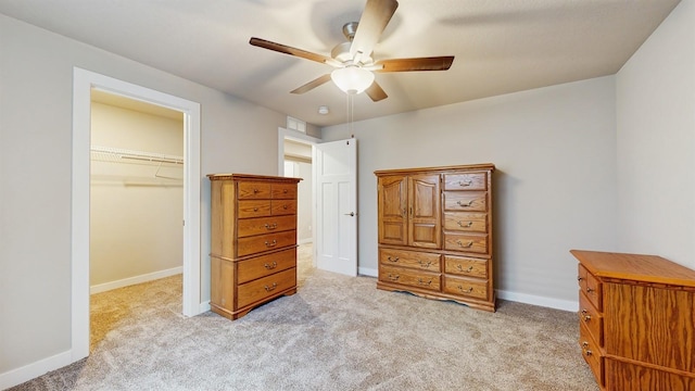 469 SE Hollow Ct, West Des Moines, IA 50265 - bedroom with light carpet, a walk in closet, a closet, and ceiling fan