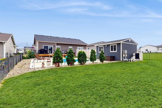 469 SE Hollow Ct, West Des Moines, IA 50265 - rear view of house with a fenced backyard, an outbuilding, and a patio
