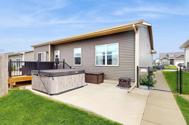 469 SE Hollow Ct, West Des Moines, IA 50265 - back of house with a hot tub, a gate, and a patio