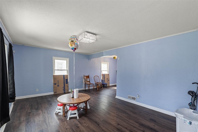 1428 E Tiffin Ave, Des Moines, IA 50316 - sitting room with a textured ceiling, wood finished floors, and crown molding