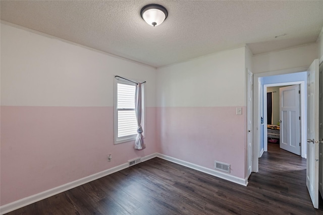 1428 E Tiffin Ave, Des Moines, IA 50316 - unfurnished room featuring dark wood-type flooring and a textured ceiling