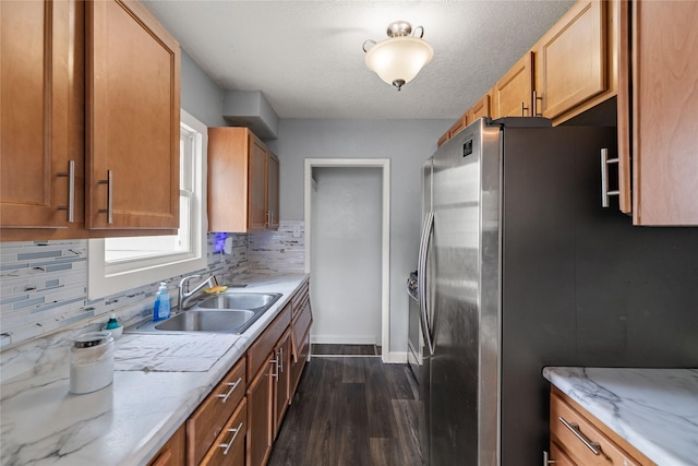 1428 E Tiffin Ave, Des Moines, IA 50316 - kitchen featuring stainless steel fridge, dark wood-type flooring, decorative backsplash, and light stone countertops