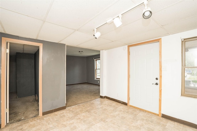 2420 Maple St, Des Moines, IA 50317 - below grade area with rail lighting, light floors, and a paneled ceiling