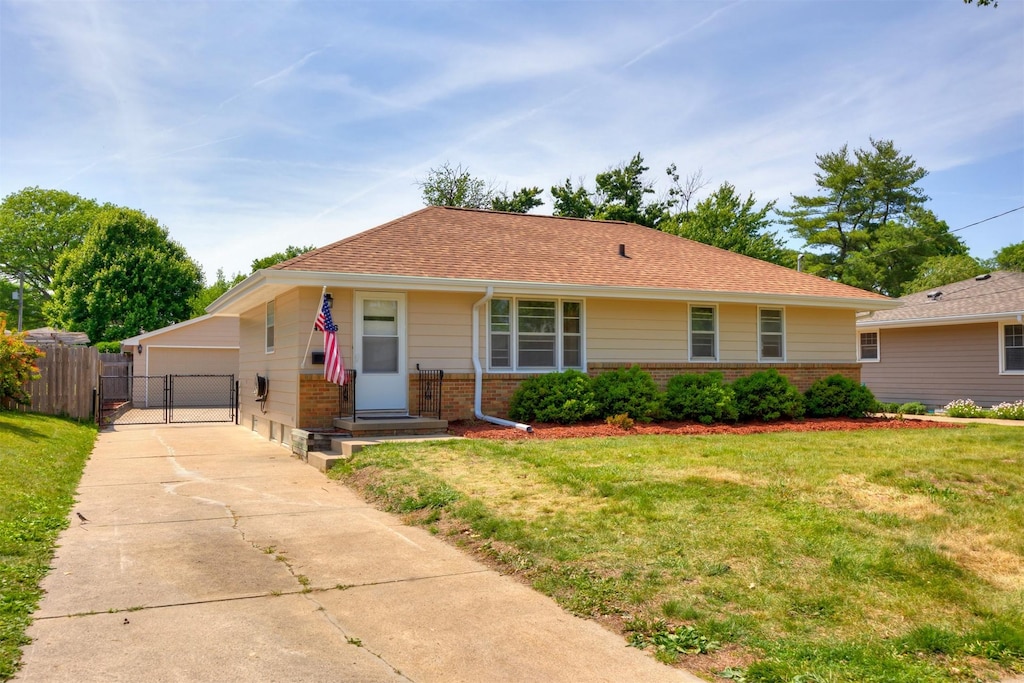 4236 40th St, Des Moines, IA 50310 - ranch-style house featuring brick siding, a gate, and a garage